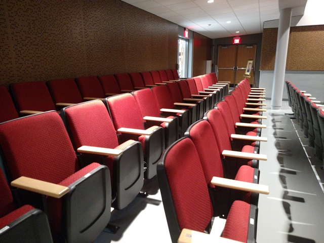 Two rows of red auditorium seats